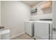 Well-equipped laundry room with modern washer and dryer and convenient storage shelves at 1588 Trentwood Dr, Fort Mill, SC 29715