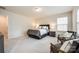 Large main bedroom with sitting area, large window, and carpeted floor at 1588 Trentwood Dr, Fort Mill, SC 29715