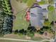 Aerial view of the home with a spacious backyard, mature trees, trampoline, and a private outdoor space at 16636 Flintrock Falls Ln, Charlotte, NC 28278