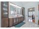 Bathroom featuring double sinks, marble countertop, and custom cabinets at 16636 Flintrock Falls Ln, Charlotte, NC 28278