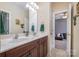 Bathroom with double sink vanity, neutral walls, and an open doorway to the bedroom at 16636 Flintrock Falls Ln, Charlotte, NC 28278