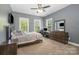Bedroom featuring a bed, work space, dresser and neutral colored walls at 16636 Flintrock Falls Ln, Charlotte, NC 28278