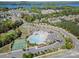 Overhead view of the community pool, clubhouse, playground, and tennis courts in a neighborhood setting at 16636 Flintrock Falls Ln, Charlotte, NC 28278