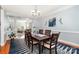 Elegant dining room with hardwood floors, chandelier, and views into living spaces for easy entertaining at 16636 Flintrock Falls Ln, Charlotte, NC 28278