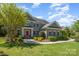 Charming two-story brick home featuring a red front door, manicured landscaping, and a well-maintained lawn at 16636 Flintrock Falls Ln, Charlotte, NC 28278