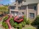 Aerial view of a multi-level deck connected to a brick house, surrounded by lush greenery at 16636 Flintrock Falls Ln, Charlotte, NC 28278