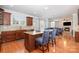 Open kitchen with cherry cabinets and a spacious island with barstool seating at 16636 Flintrock Falls Ln, Charlotte, NC 28278