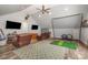 A bonus room featuring leather chairs, and a golf net, perfect for sports and relaxation at 16636 Flintrock Falls Ln, Charlotte, NC 28278