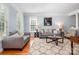 Comfortable living room featuring hardwood floors, neutral decor, and large windows that brighten the room at 16636 Flintrock Falls Ln, Charlotte, NC 28278
