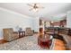Spacious living room with hardwood floors, an open layout, and seamless flow into the kitchen and dining area at 16636 Flintrock Falls Ln, Charlotte, NC 28278