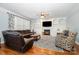 Cozy living room with a fireplace, built-in shelving, hardwood floors, and comfortable seating area at 16636 Flintrock Falls Ln, Charlotte, NC 28278