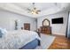 Spacious primary bedroom with trey ceiling, ceiling fan, wood floors, and stylish decor at 16636 Flintrock Falls Ln, Charlotte, NC 28278