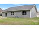 Backyard with gray siding, green grass, and sliding glass door, perfect for outdoor living and entertaining at 1706 30Th Avenue Ne Ct, Hickory, NC 28601