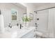 Stylish bathroom featuring a tub and shower combo, a white vanity, and modern matte black fixtures at 1706 30Th Avenue Ne Ct, Hickory, NC 28601