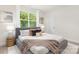 Bedroom with large window, plush bedding, and stylish side tables at 1706 30Th Avenue Ne Ct, Hickory, NC 28601