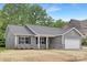Inviting single-story home with gray siding, stone veneer accents, and a two-car garage for modern comfort at 1706 30Th Avenue Ne Ct, Hickory, NC 28601