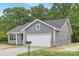 Gray sided single-story home with a two-car garage and a manicured lawn, perfect for suburban living at 1706 30Th Avenue Ne Ct, Hickory, NC 28601