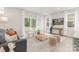 Bright living room featuring neutral tones, modern furnishings, and natural light streaming through large windows at 1706 30Th Avenue Ne Ct, Hickory, NC 28601