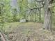 Backyard with a shed, mature trees, and natural surroundings, offering a private and secluded outdoor space at 171 Westmoreland Rd, Mooresville, NC 28115