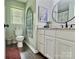 Bathroom featuring a vanity with a granite countertop, a toilet, and stylish decor at 171 Westmoreland Rd, Mooresville, NC 28115