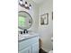 Bathroom featuring a vanity with a granite countertop, black faucet and stylish decor at 171 Westmoreland Rd, Mooresville, NC 28115