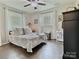 Bedroom has a ceiling fan, two windows, and dark hardwood floors at 171 Westmoreland Rd, Mooresville, NC 28115