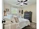 The bedroom has a large window, a ceiling fan, and dark hardwood floors at 171 Westmoreland Rd, Mooresville, NC 28115