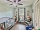 Bright bedroom with charming decor, featuring a crib, gray walls, and hardwood floors at 171 Westmoreland Rd, Mooresville, NC 28115