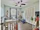 room with gray walls, featuring a crib, decor, gray curtains, and double door closet at 171 Westmoreland Rd, Mooresville, NC 28115