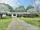 Quaint single-story brick home with a driveway, well-manicured lawn, and mature trees at 171 Westmoreland Rd, Mooresville, NC 28115
