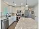 Well-lit kitchen featuring stainless appliances, granite counters, and ample cabinetry at 171 Westmoreland Rd, Mooresville, NC 28115