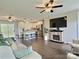 Open-concept living room flows into the kitchen, featuring modern fixtures and a stone fireplace at 171 Westmoreland Rd, Mooresville, NC 28115