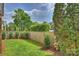 This grassy, fenced backyard offers privacy and space for outdoor activities and relaxation at 1824 Hall Ave, Charlotte, NC 28205