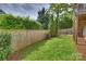 A well-maintained lawn is enclosed by a wooden fence, providing a safe and private outdoor area at 1824 Hall Ave, Charlotte, NC 28205