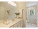 Bright bathroom featuring a single vanity sink, a mirror, and a shower with curtain at 1824 Hall Ave, Charlotte, NC 28205