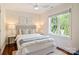 Comfortable bedroom featuring a large window, a bed with neutral bedding, and two side tables at 1824 Hall Ave, Charlotte, NC 28205