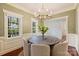 Elegant dining room featuring a stylish chandelier, hardwood floors, and large windows for natural light at 1824 Hall Ave, Charlotte, NC 28205