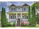 Charming two-story home featuring a welcoming front porch, beautiful landscaping, and classic architectural details at 1824 Hall Ave, Charlotte, NC 28205