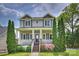 Charming two-story home boasts a welcoming front porch, well-manicured landscaping, and classic architectural details at 1824 Hall Ave, Charlotte, NC 28205