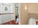 Hallway with hardwood floors, white railings, and a view into the living room at 1824 Hall Ave, Charlotte, NC 28205