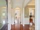 Bright and spacious hallway with hardwood floors and arched doorways leading to various rooms at 1824 Hall Ave, Charlotte, NC 28205