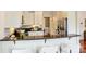 Bright kitchen bar featuring black countertops, white cabinets, stainless steel appliances, and stainless steel faucet at 1824 Hall Ave, Charlotte, NC 28205