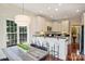 Sunny breakfast nook with table and kitchen bar, complemented by modern lighting and ample counter space at 1824 Hall Ave, Charlotte, NC 28205