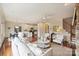 Inviting living room with hardwood floors, white furniture, and seamless flow to the kitchen and dining area at 1824 Hall Ave, Charlotte, NC 28205