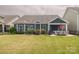 Beautiful backyard with lush green grass, patio furniture, and a well-maintained fence at 18721 Dumbarton Oaks Dr, Cornelius, NC 28031