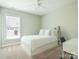 Bright bedroom with a clean design, featuring a bed with built-in storage and a large window at 18721 Dumbarton Oaks Dr, Cornelius, NC 28031