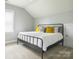 Light-filled bedroom with neutral carpet and a comfortable queen-sized bed with a metal frame at 18721 Dumbarton Oaks Dr, Cornelius, NC 28031
