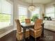 Dining area with wicker chairs, large windows, and modern chandelier at 18721 Dumbarton Oaks Dr, Cornelius, NC 28031