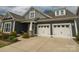 Attractive exterior with a two-car garage, stone accents, and a covered porch at 18721 Dumbarton Oaks Dr, Cornelius, NC 28031