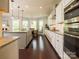 A spacious kitchen with stainless appliances, granite countertops, and dark hardwood floors at 18721 Dumbarton Oaks Dr, Cornelius, NC 28031
